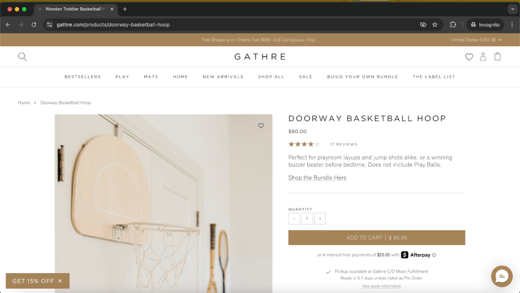 A wooden doorway basketball hoop displayed on a wall, featuring a minimalist design. The product page includes pricing and a brief description highlighting its suitability for playrooms.